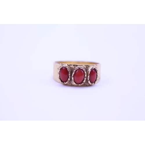 92 - An 18ct Gold Ring set with coral stones. Weight approx 4.5g. Size approx Q.