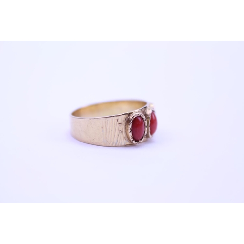 92 - An 18ct Gold Ring set with coral stones. Weight approx 4.5g. Size approx Q.