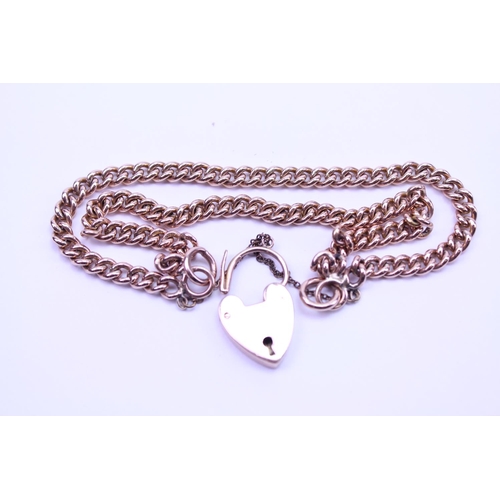 94 - A 9ct Gold double chain bracelet set with a love heart locket and safety chain. Total weight 28.5g.