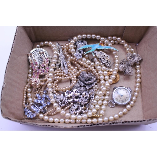 101 - A collection of costume jewellery to include brooches, 'pearls', etc.