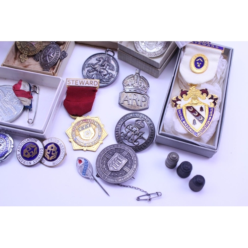 375 - A quantity of Militaria to include Mason badges, a defence medal along with various other associatio... 