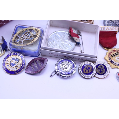 375 - A quantity of Militaria to include Mason badges, a defence medal along with various other associatio... 