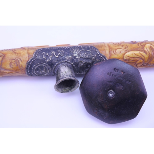 892 - A Bone mounted Opium Pipe along with one other with floral decoration.