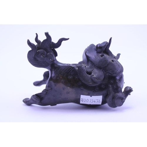 906 - An Chinese bronze study of a Foo dog. AF. Size approx 11cm.