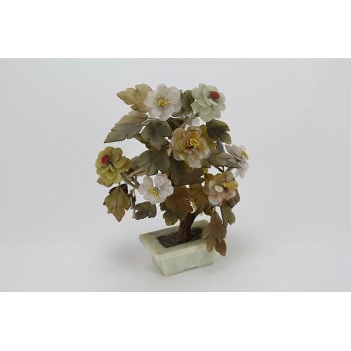 907 - A Chinese design Jade and hard stone study of a bonsai tree in full flower contained on a green hard... 