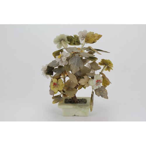 907 - A Chinese design Jade and hard stone study of a bonsai tree in full flower contained on a green hard... 