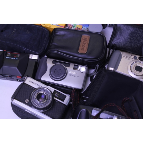 729 - A Collection of Cameras to include an Olympus Trip 35, a Praktica, Nikon Zoom 4, etc along with a pa... 