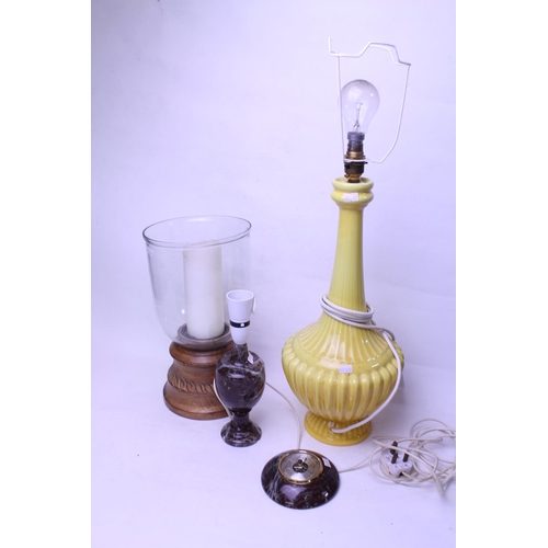 636 - A Storm Lamp with a wooden base, a Yellow Glazed Onion Neck Lamp & two items of Cornish Serpentine.