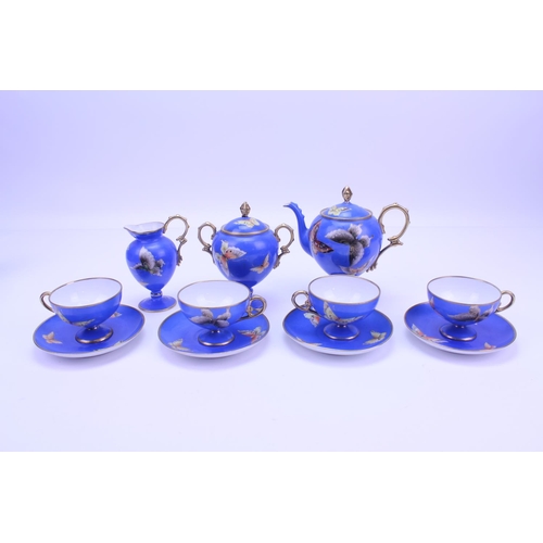 546 - A Beautiful Noritake Tea Set for 4 in Blue & Gold with a Butterfly pattern to include a Tea Pot, Fou... 