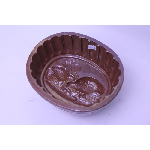 560 - A Late 19th Century Stoneware Glazed Aspic Jelly Mould decorated with quails.