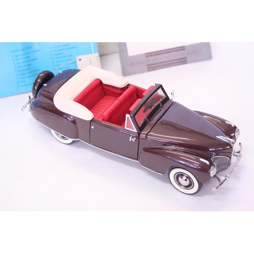 159 - A Franklin Mint 1941 Lincoln Continental finished in Dark Maroon. The model appears to be in Mint Co... 