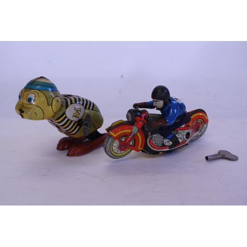 324 - A 1950s Clockwork Tin Plate Motor Cycle with Rider along with a 1950s YONE Toys of Japan Clockwork T... 