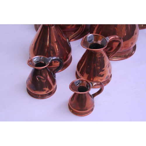 509 - A Copper Ale Measurer along with a Graduation of Measure Jugs.