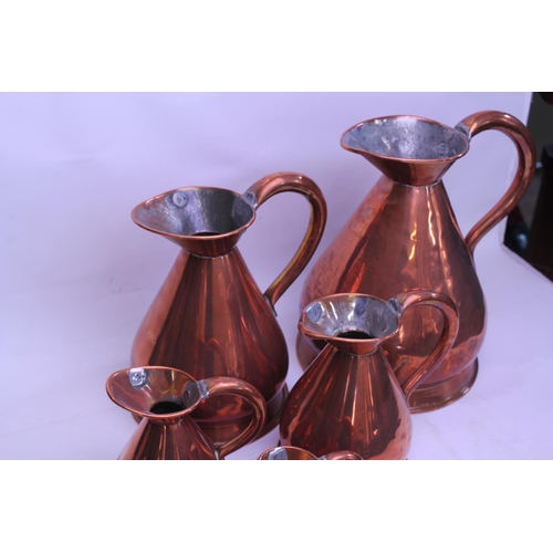 509 - A Copper Ale Measurer along with a Graduation of Measure Jugs.