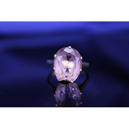 233 - A 9ct Gold Dress Ring mounted with a Purple Stone. Size: Q. Weighing: 5.2 grams Gross.