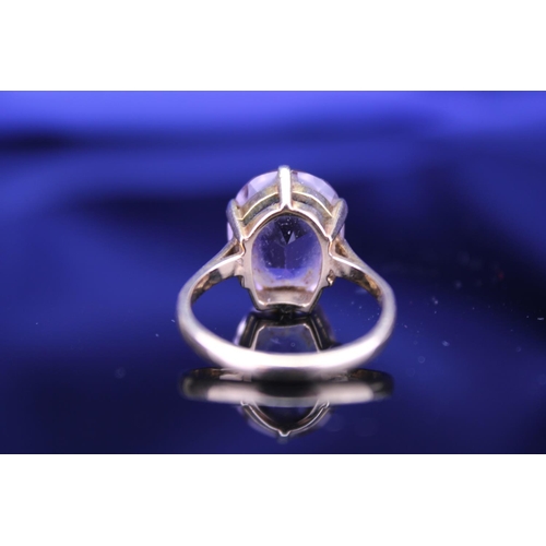 233 - A 9ct Gold Dress Ring mounted with a Purple Stone. Size: Q. Weighing: 5.2 grams Gross.