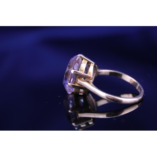 233 - A 9ct Gold Dress Ring mounted with a Purple Stone. Size: Q. Weighing: 5.2 grams Gross.