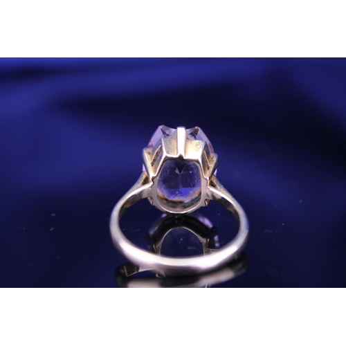 233 - A 9ct Gold Dress Ring mounted with a Purple Stone. Size: Q. Weighing: 5.2 grams Gross.