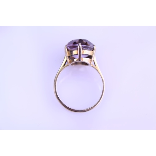 233 - A 9ct Gold Dress Ring mounted with a Purple Stone. Size: Q. Weighing: 5.2 grams Gross.