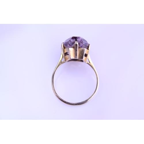 233 - A 9ct Gold Dress Ring mounted with a Purple Stone. Size: Q. Weighing: 5.2 grams Gross.