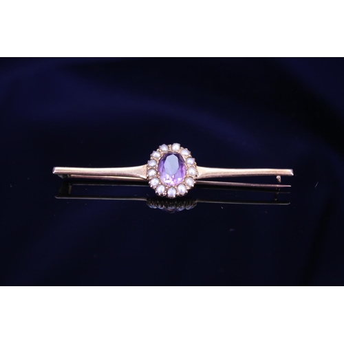 235 - A Gold coloured amethyst and pearl set brooch. Total weight approx 4.7g. Brooch size approx 6.5cm. A... 