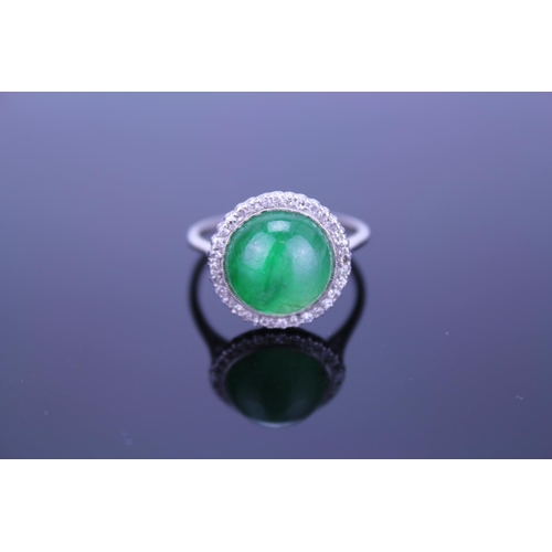 257 - A Beautiful jade cabochon ring surrounded by small diamonds. Size approximately 0.5cm deep x 0.8cm d... 