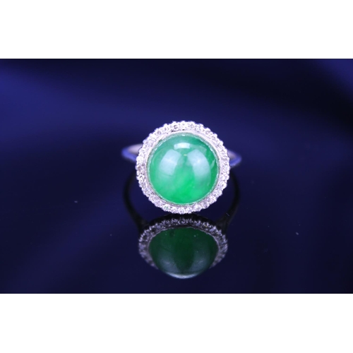 257 - A Beautiful jade cabochon ring surrounded by small diamonds. Size approximately 0.5cm deep x 0.8cm d... 