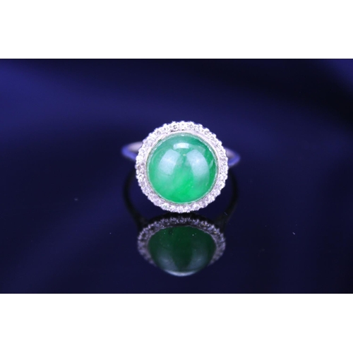 257 - A Beautiful jade cabochon ring surrounded by small diamonds. Size approximately 0.5cm deep x 0.8cm d... 