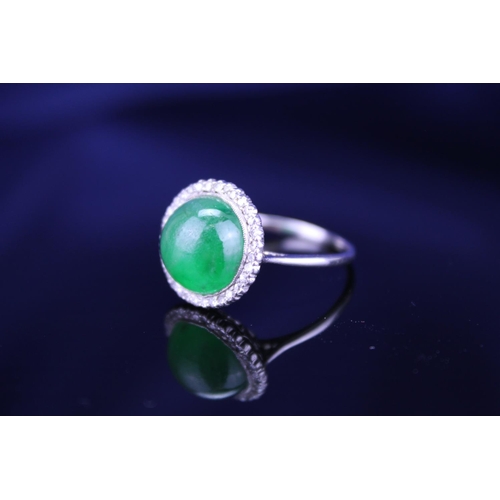 257 - A Beautiful jade cabochon ring surrounded by small diamonds. Size approximately 0.5cm deep x 0.8cm d... 