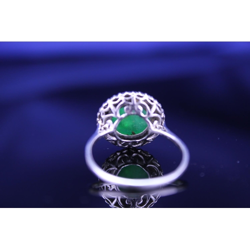 257 - A Beautiful jade cabochon ring surrounded by small diamonds. Size approximately 0.5cm deep x 0.8cm d... 