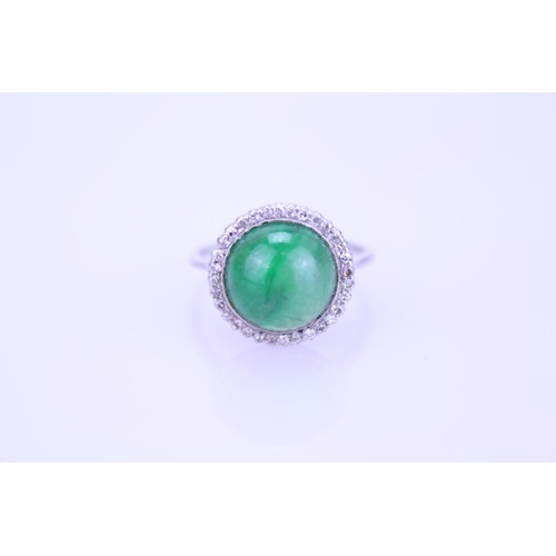 257 - A Beautiful jade cabochon ring surrounded by small diamonds. Size approximately 0.5cm deep x 0.8cm d... 