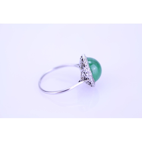 257 - A Beautiful jade cabochon ring surrounded by small diamonds. Size approximately 0.5cm deep x 0.8cm d... 