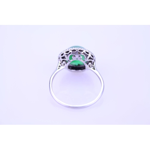 257 - A Beautiful jade cabochon ring surrounded by small diamonds. Size approximately 0.5cm deep x 0.8cm d... 