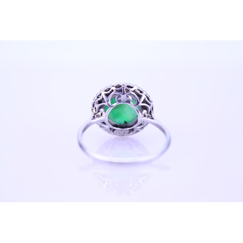 257 - A Beautiful jade cabochon ring surrounded by small diamonds. Size approximately 0.5cm deep x 0.8cm d... 