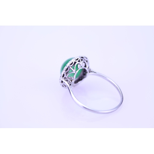 257 - A Beautiful jade cabochon ring surrounded by small diamonds. Size approximately 0.5cm deep x 0.8cm d... 