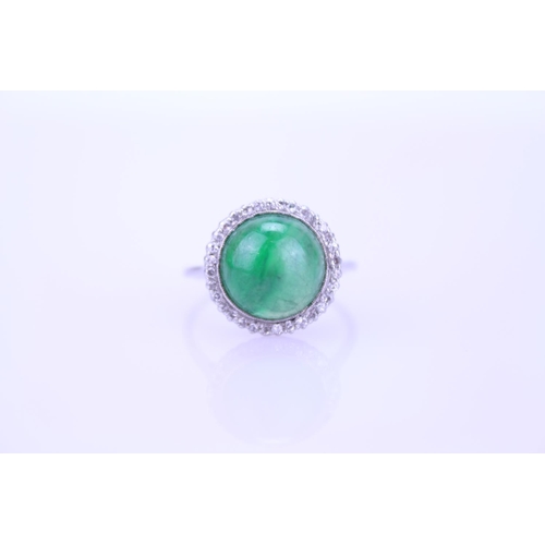 257 - A Beautiful jade cabochon ring surrounded by small diamonds. Size approximately 0.5cm deep x 0.8cm d... 