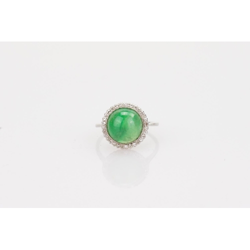 257 - A Beautiful jade cabochon ring surrounded by small diamonds. Size approximately 0.5cm deep x 0.8cm d... 