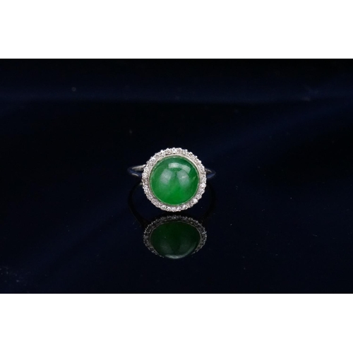 257 - A Beautiful jade cabochon ring surrounded by small diamonds. Size approximately 0.5cm deep x 0.8cm d... 