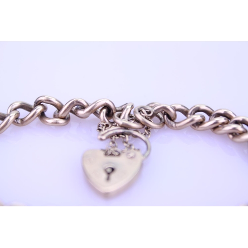 258 - A Ladies 9ct Gold curb link bracelet mounted with a heart locket, marked A S J. Weight approximately... 