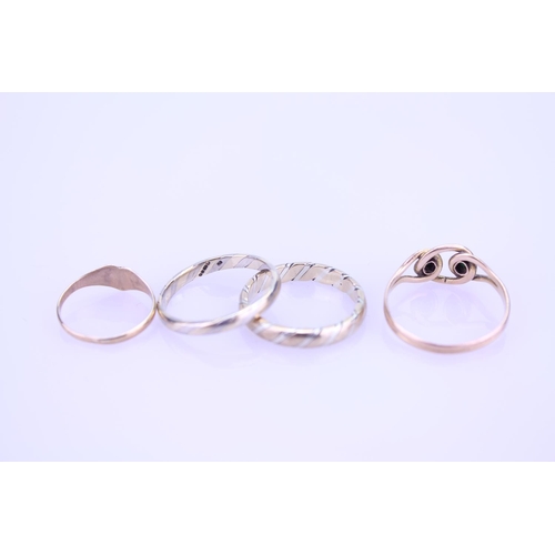 262 - A collection of four 9ct Gold rings including a wedding band set, a turquoise ring along with a chil... 