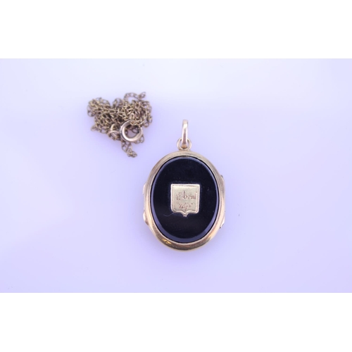 240 - A Beautiful Onyx double sided pendant 1870 inscribed on the pendant, hung on a Gold coloured chain. ... 