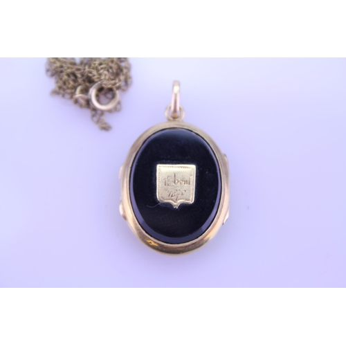 240 - A Beautiful Onyx double sided pendant 1870 inscribed on the pendant, hung on a Gold coloured chain. ... 