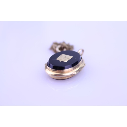 240 - A Beautiful Onyx double sided pendant 1870 inscribed on the pendant, hung on a Gold coloured chain. ... 