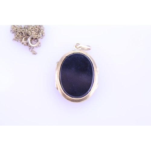 240 - A Beautiful Onyx double sided pendant 1870 inscribed on the pendant, hung on a Gold coloured chain. ... 