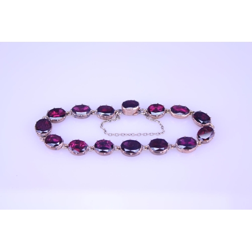 242 - A Beautiful Garnet and 9ct Gold Victorian bracelet mounted with 14 oval garnets (varying in size). G... 