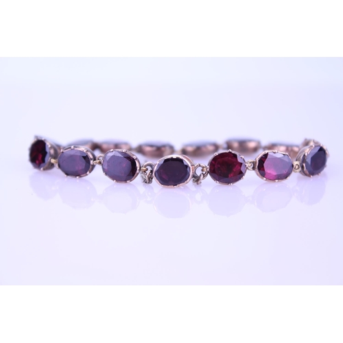 242 - A Beautiful Garnet and 9ct Gold Victorian bracelet mounted with 14 oval garnets (varying in size). G... 