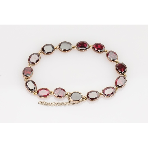 242 - A Beautiful Garnet and 9ct Gold Victorian bracelet mounted with 14 oval garnets (varying in size). G... 