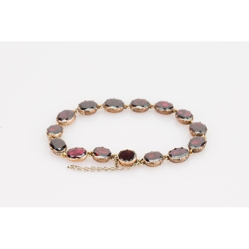 242 - A Beautiful Garnet and 9ct Gold Victorian bracelet mounted with 14 oval garnets (varying in size). G... 