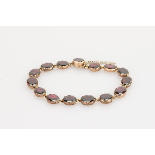 242 - A Beautiful Garnet and 9ct Gold Victorian bracelet mounted with 14 oval garnets (varying in size). G... 