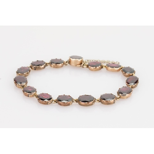 242 - A Beautiful Garnet and 9ct Gold Victorian bracelet mounted with 14 oval garnets (varying in size). G... 